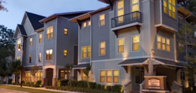Modern apartment buildings with lit windows exterior at Heritage Oaks Luxury Apartments in Gainesville Student Accommodation