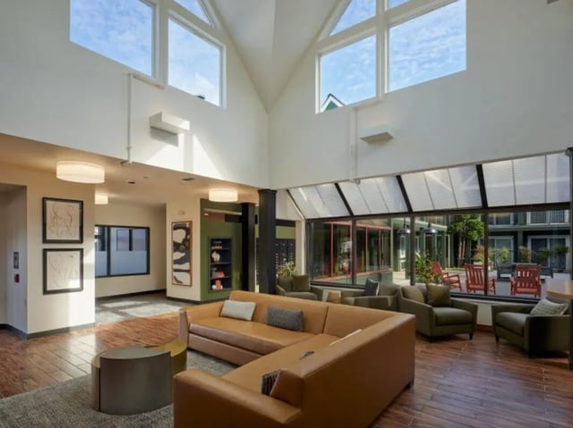 Modern lounge with sectional sofa and armchairs living room at Goose Hollow Tower and Goose Hollow Plaza in Portland Student Accommodation