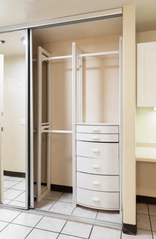 Mirrored closet with drawers and hanging rods Closet at Dixie Cove Student Housing in St. George Student Accommodation