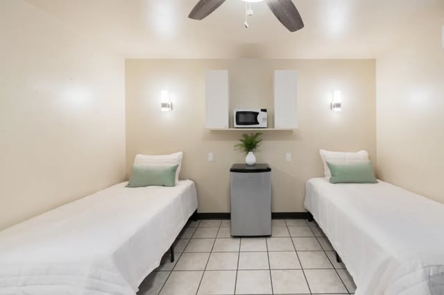 Two beds microwave mini fridge bedroom at Dixie Cove Student Housing in St. George Student Accommodation
