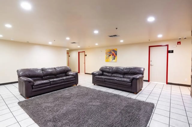 Two leather sofas on rug in lounge area at Dixie Cove Student Housing in St. George Student Accommodation