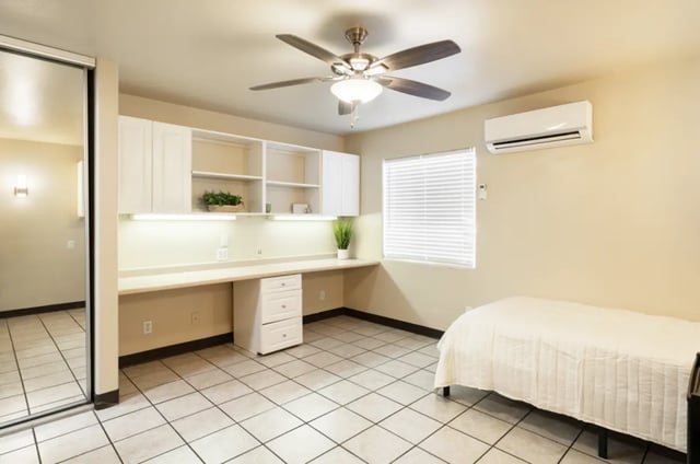 Desk bed mirrored wardrobe ceiling fan bedroom at Dixie Cove Student Housing in St. George Student Accommodation