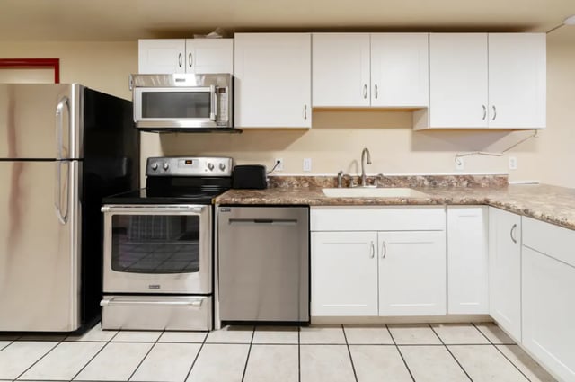 Refrigerator stove microwave sink and dishwasher kitchen at Dixie Cove Student Housing in St. George Student Accommodation