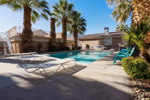 Poolside lounge chairs and turquoise chairs exterior at Dixie Cove Student Housing in St. George Student Accommodation
