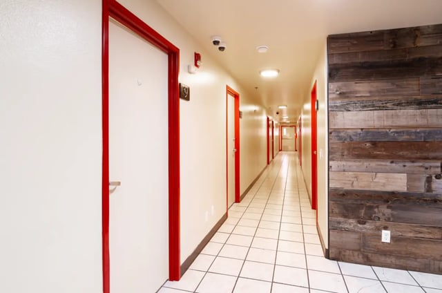 Hallway with tiled floor and red doors hallway at Dixie Cove Student Housing in St. George Student Accommodation