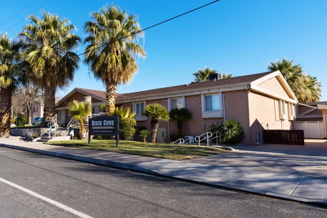 Dixie Cove sign palm trees building exterior at Dixie Cove Student Housing in St. George Student Accommodation