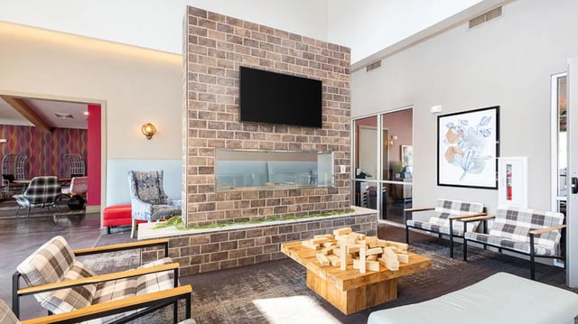 Chairs television fireplace coffee table living room at Hawks Landing Apartments in Cape Girardeau Student Accommodation