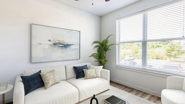 White sofa artwork plant and window living room at Hawks Landing Apartments in Cape Girardeau Student Accommodation