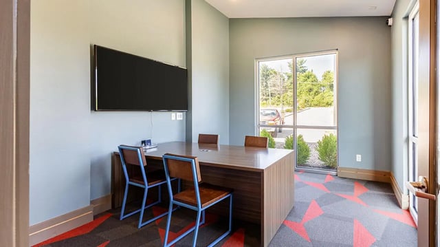 Table with chairs and television study area at Hawks Landing Apartments in Cape Girardeau Student Accommodation