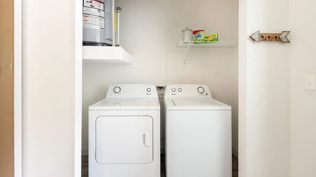 Two white washing machines and dryer Laundry room at Hawks Landing Apartments in Cape Girardeau Student Accommodation
