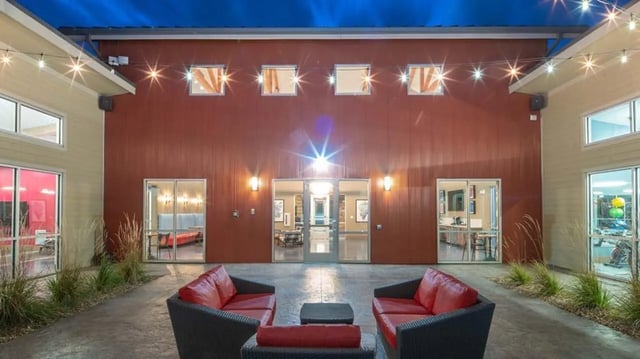 Courtyard with red couches and string lights exterior at Hawks Landing Apartments in Cape Girardeau Student Accommodation