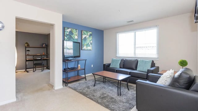 Sofas coffee table TV and study area living room at Village at Bluegrass in Mount Pleasant Student Accommodation