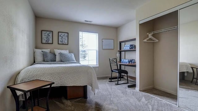 Bed desk closet and window bedroom at Village at Bluegrass in Mount Pleasant Student Accommodation