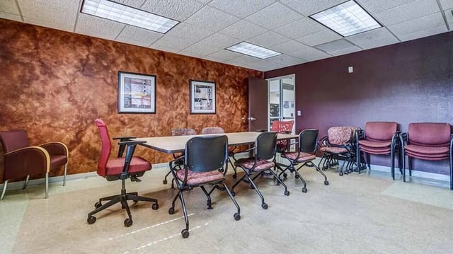 Table with chairs and artwork Meeting room at Village at Bluegrass in Mount Pleasant Student Accommodation