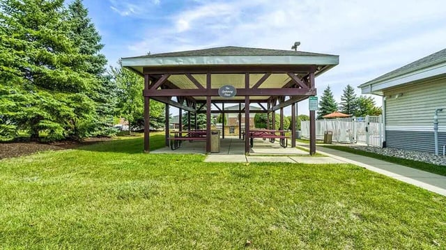 Pavilion with picnic tables and trash can outdoor area at Village at Bluegrass in Mount Pleasant Student Accommodation