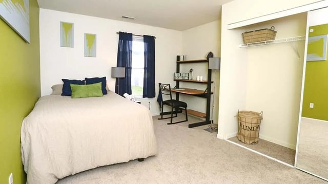 Bed desk chair laundry hamper bedroom study area at Village at Bluegrass in Mount Pleasant Student Accommodation