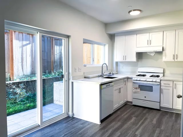 White cabinets sink dishwasher stove kitchen at Husky Urban Living in Seattle Student Accommodation