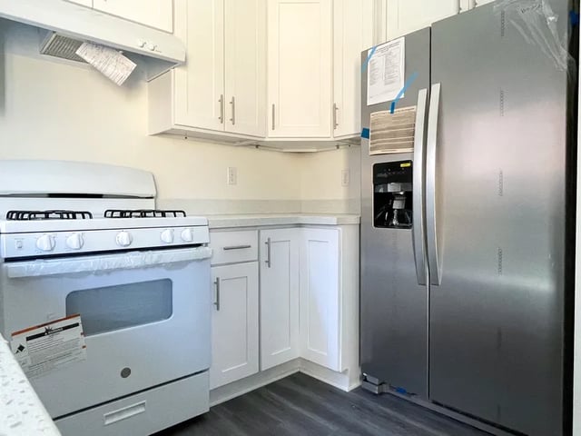White stove stainless steel refrigerator kitchen at Husky Urban Living in Seattle Student Accommodation