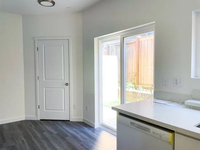 White door sliding door countertop dishwasher kitchen at Husky Urban Living in Seattle Student Accommodation