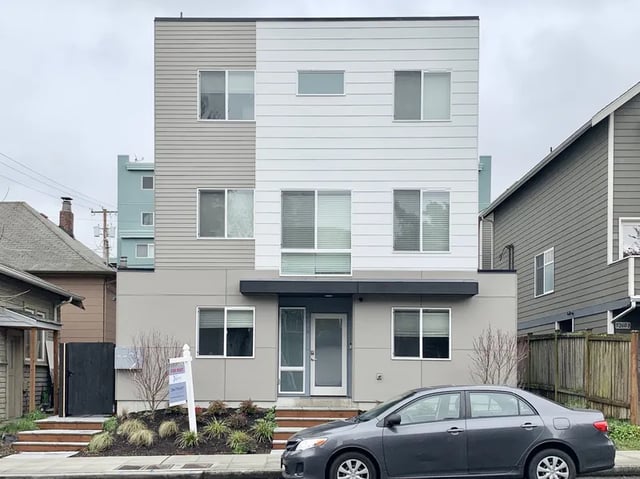 Modern apartment building with car and for rent sign exterior at Husky Urban Living in Seattle Student Accommodation
