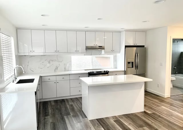 White cabinets stainless steel fridge kitchen island kitchen at Husky Urban Living in Seattle Student Accommodation