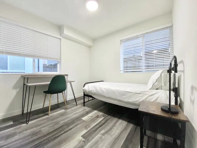 Bed desk chair and nightstand bedroom at Husky Urban Living in Seattle Student Accommodation