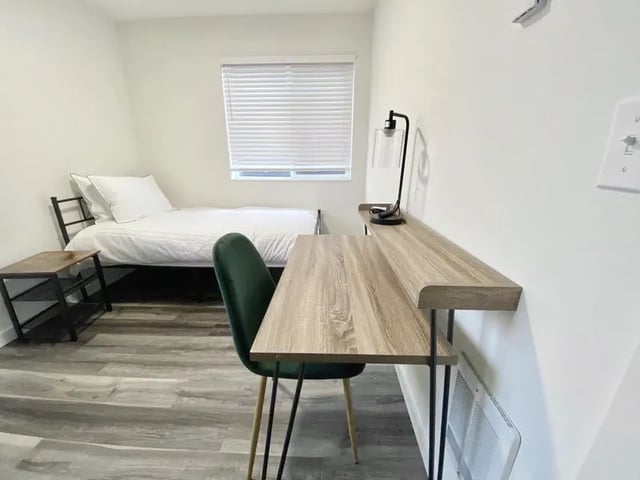 Bed desk chair lamp shelf bedroom study area at Husky Urban Living in Seattle Student Accommodation