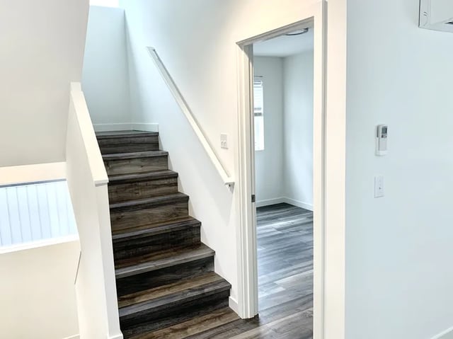 Wooden stairs leading upstairs open doorway interior view at Husky Urban Living in Seattle Student Accommodation