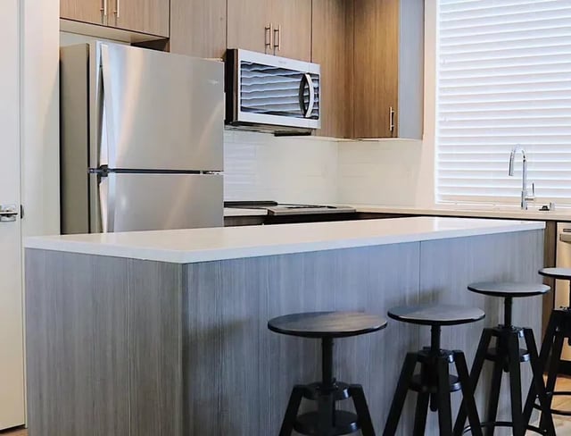 Stainless steel fridge microwave counter bar stools kitchen at Husky Urban Living in Seattle Student Accommodation