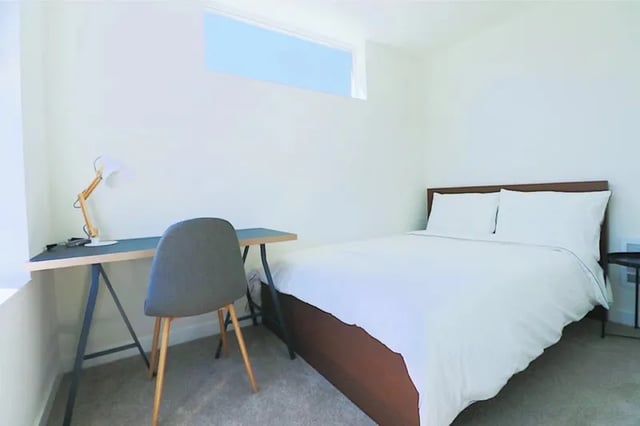 Bed desk chair lamp bedroom at Husky Urban Living in Seattle Student Accommodation