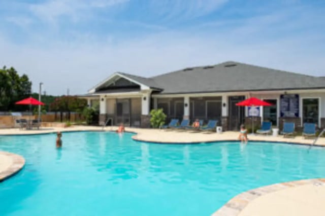 Pool with lounge chairs and building exterior at Preserve at Tech in Ruston Student Accommodation