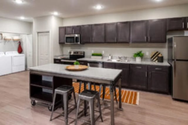 Kitchen island appliances dark cabinets laundry area kitchen at Preserve at Tech in Ruston Student Accommodation