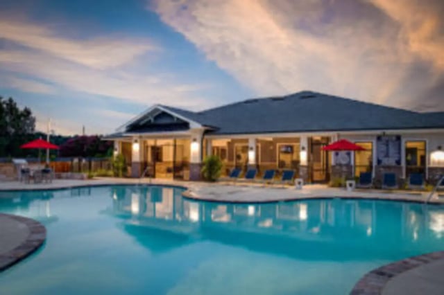 Pool with lounge chairs building exterior at Preserve at Tech in Ruston Student Accommodation