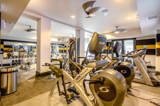 Gym equipment with exercise machines and weights Gym at The Den Apartments in Berkeley Student Accommodation