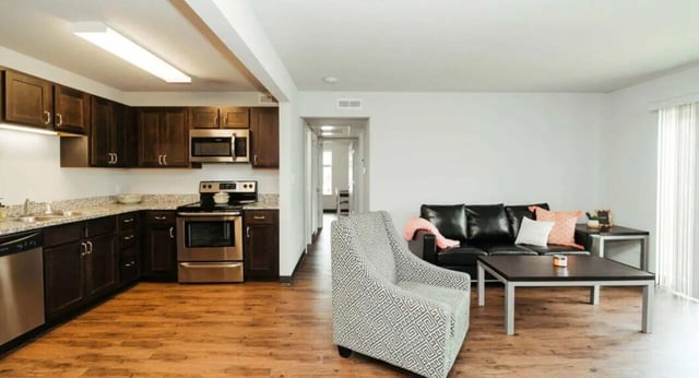 Kitchen living area with patterned armchair and sofa at MadisonVue Apartments in Springfield Student Accommodation
