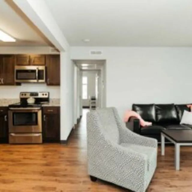 Kitchen oven chairs sofa living room at MadisonVue Apartments in Springfield Student Accommodation