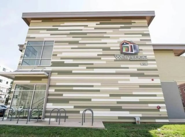 Building exterior with striped siding bike racks exterior at Magers Apartments in Springfield Student Accommodation