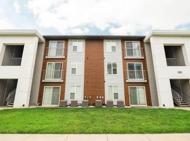 Apartment building with balconies windows and grass exterior at Magers Apartments in Springfield Student Accommodation