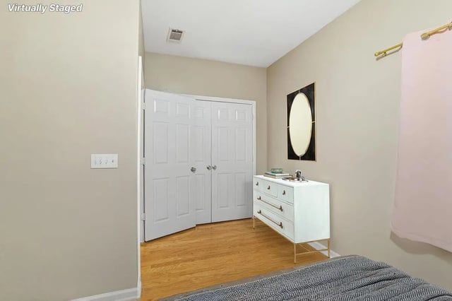 White dresser oval mirror double doors bedroom at Stadium Properties Apartments in Tallahassee Student Accommodation