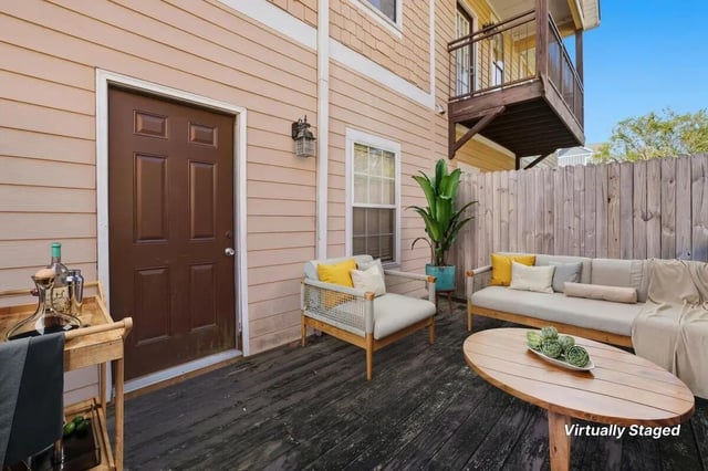 Patio with sofa chairs table and plant exterior at Stadium Properties Apartments in Tallahassee Student Accommodation