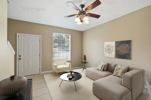 Sofa armchair coffee table artwork living room at Stadium Properties Apartments in Tallahassee Student Accommodation
