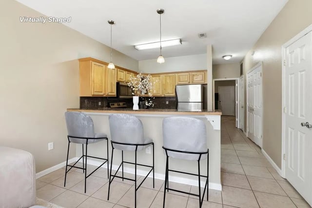 Three grey bar stools at kitchen counter kitchen at Stadium Properties Apartments in Tallahassee Student Accommodation
