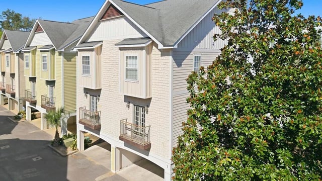 Townhouses with balconies and trees exterior at Stadium Properties Apartments in Tallahassee Student Accommodation