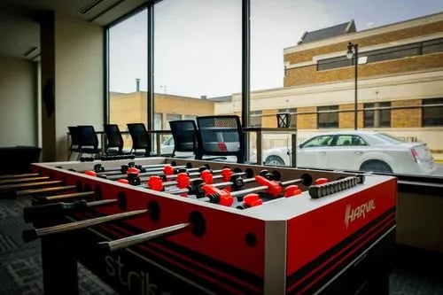 Foosball table chairs and window lounge area at Highland Quarters in Terre Haute Student Accommodation