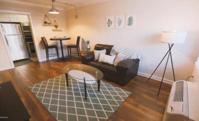 Sofa coffee table rug lamp dining table living room at Student Housing Solutions in Tallahassee Student Accommodation