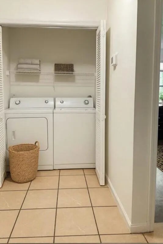 Washer dryer stacked towels basket laundry area at Villa Bella Vista in Tallahassee Student Accommodation