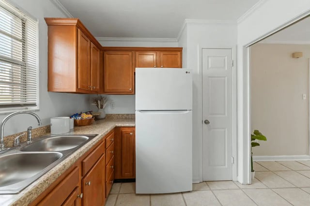 Kitchen with sink refrigerator cabinets door kitchen at Villa Capri Apartments in Tallahassee Student Accommodation