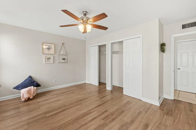 Closet doors on wood floor with pillows bedroom at Villa Capri Apartments in Tallahassee Student Accommodation