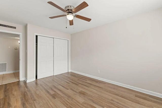 Ceiling fan and closet doors bedroom at Villa Capri Apartments in Tallahassee Student Accommodation