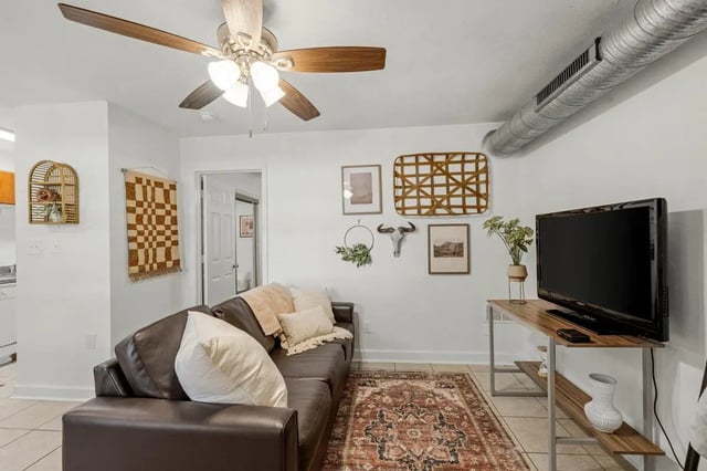 Leather sofa rug and television living room at Villa Cristina in Tallahassee Student Accommodation